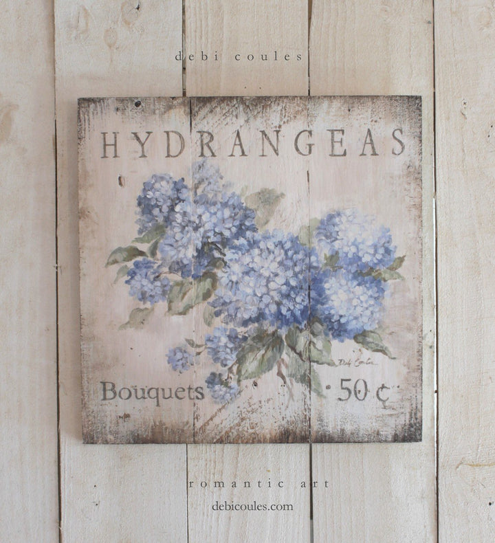 Beautiful Blue Hydrangeas on an antique white, distressed, vintage shabby chic style background. Also works with modern farmhouse. The writing states: Hydrangea bouquets 50 cents. A rustic wooden sign that would be great in kitchen, bath, or anywhere